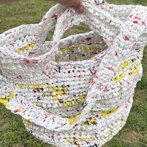 Handmade from plastic bags crocheted shopping tote bag with a pocket